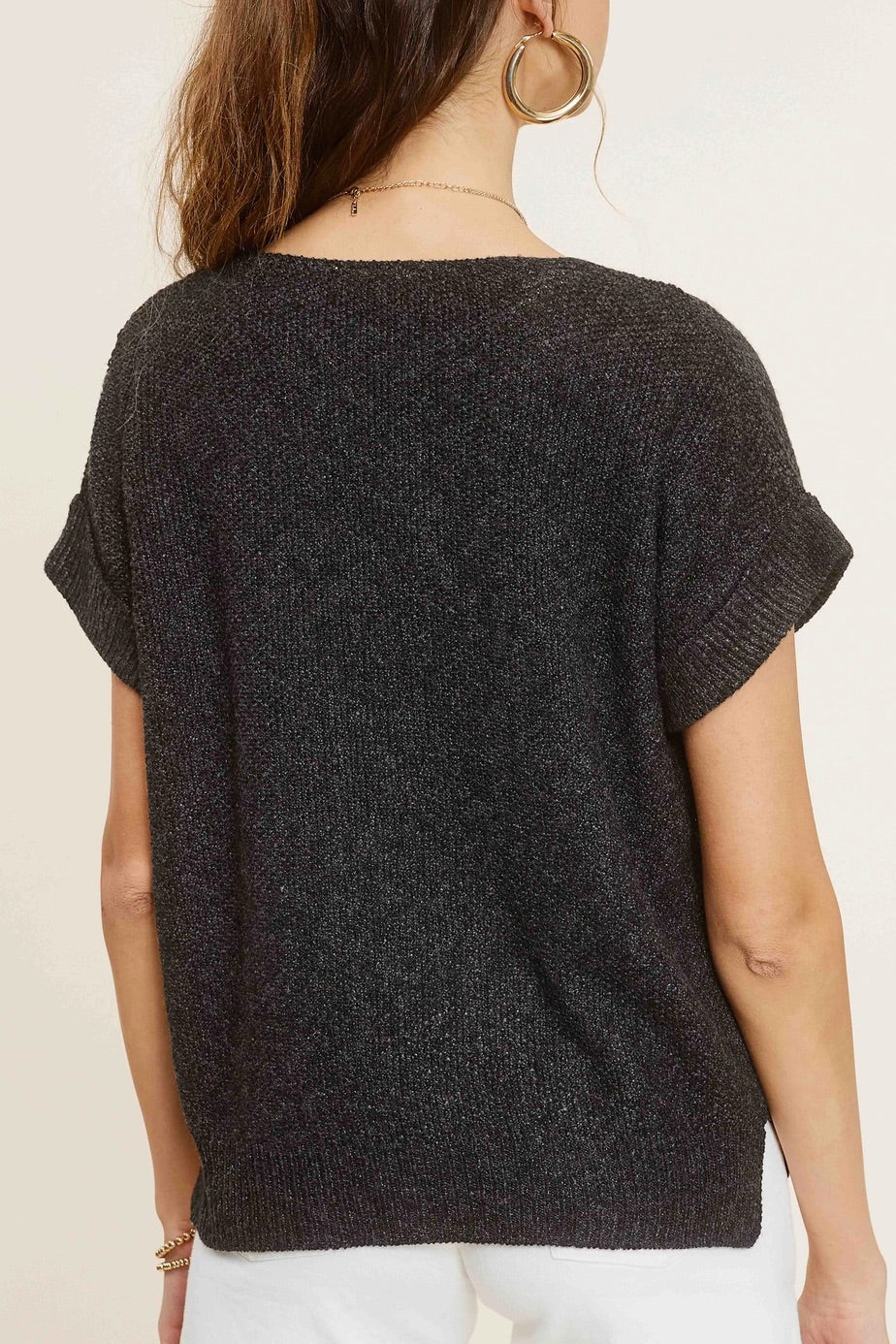 Woman wearing charcoal heather short-sleeve lightweight textured sweater with wide V-neck and side slits.