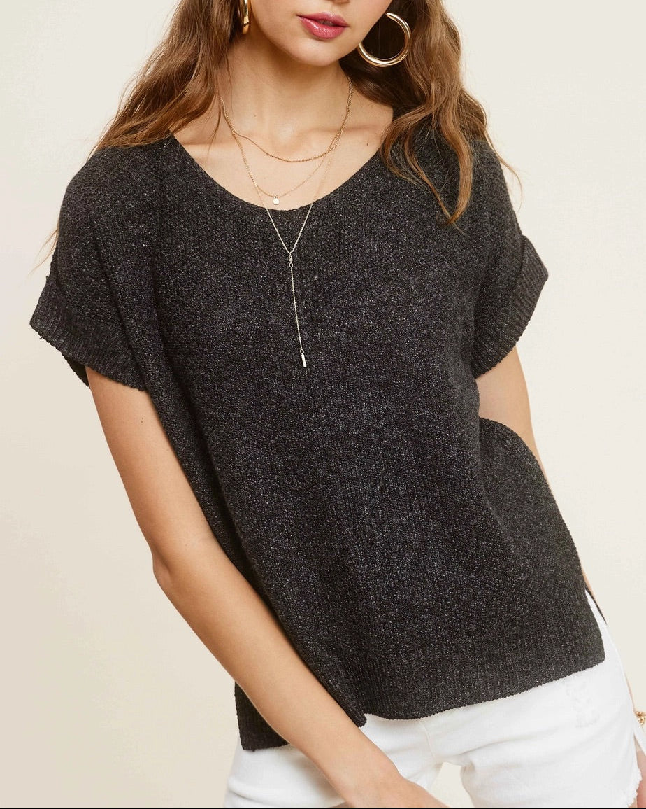 Woman wearing charcoal heather short-sleeve lightweight textured sweater with wide V-neck and side slits.
