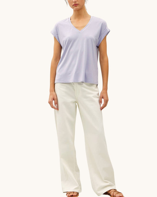 Soft modal lilac tee shirt with v-neckline paired with cream pants.