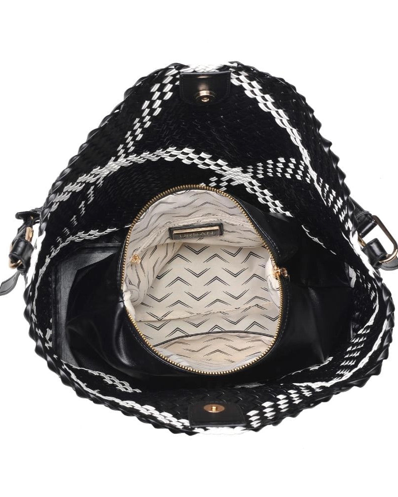 Black and white patterned handbag with open zipper showing interior.