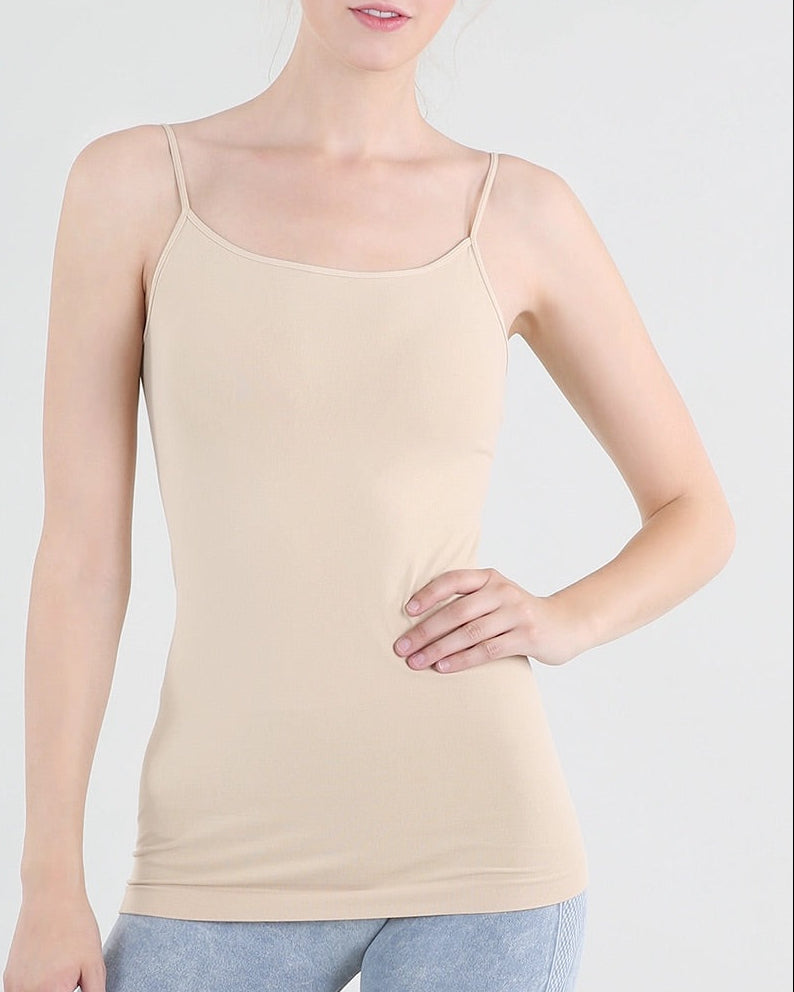 Woman wearing a beige/stone camisole against a white background.
