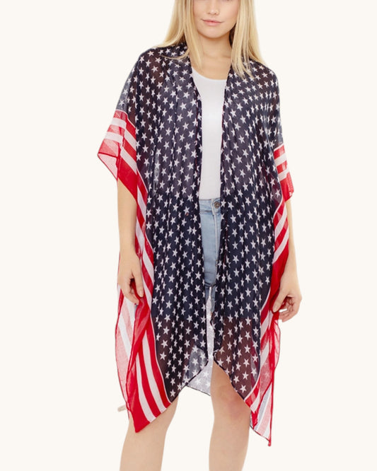 Woman wearing a American flag patterned kimono / cover up on a white background.