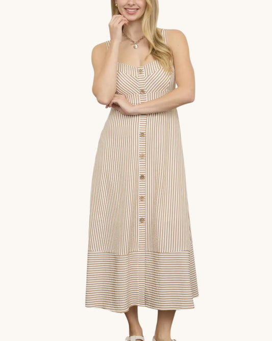 Woman wearing a beige and white striped midi dress with front buttons on a white background.