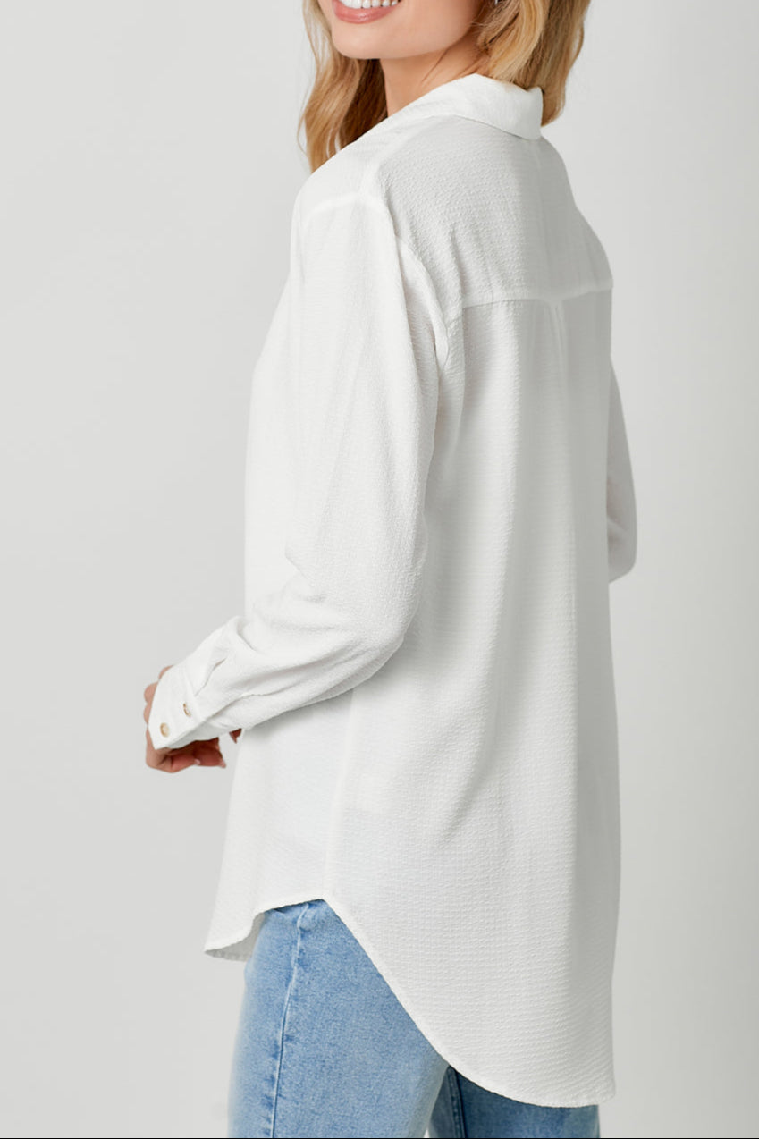 White textured lightweight button-down shirt with collared neckline.