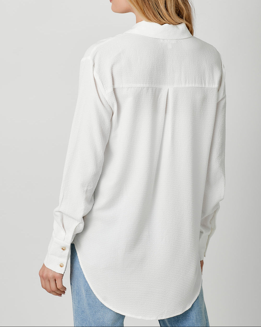 White textured lightweight button-down shirt with collared neckline.