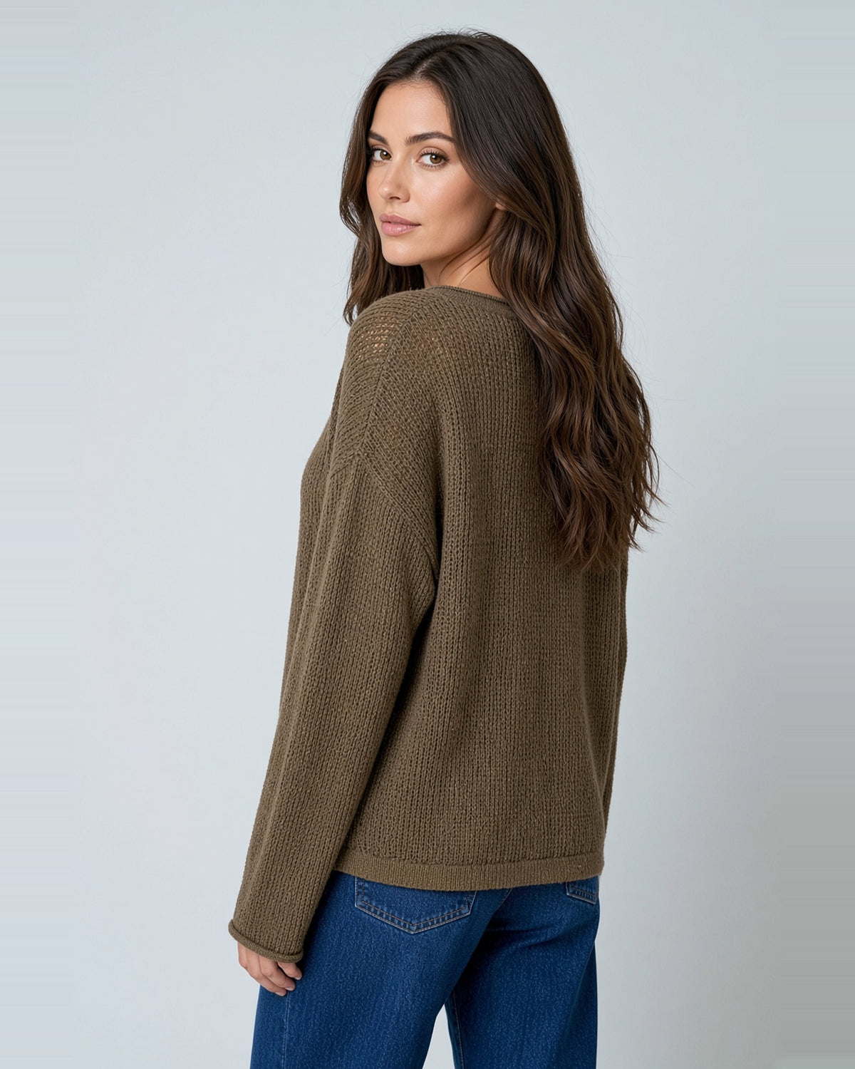 Back view of Cocoa Bean long sleeve sweater showing sheer knit texture and raw edge hem.