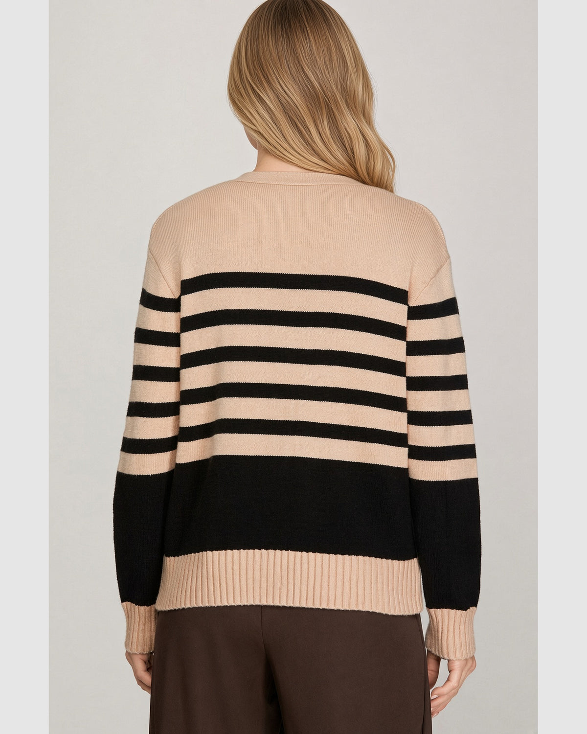 Back view of beige and black striped cardigan showing long sleeves and beige ribbed hem.