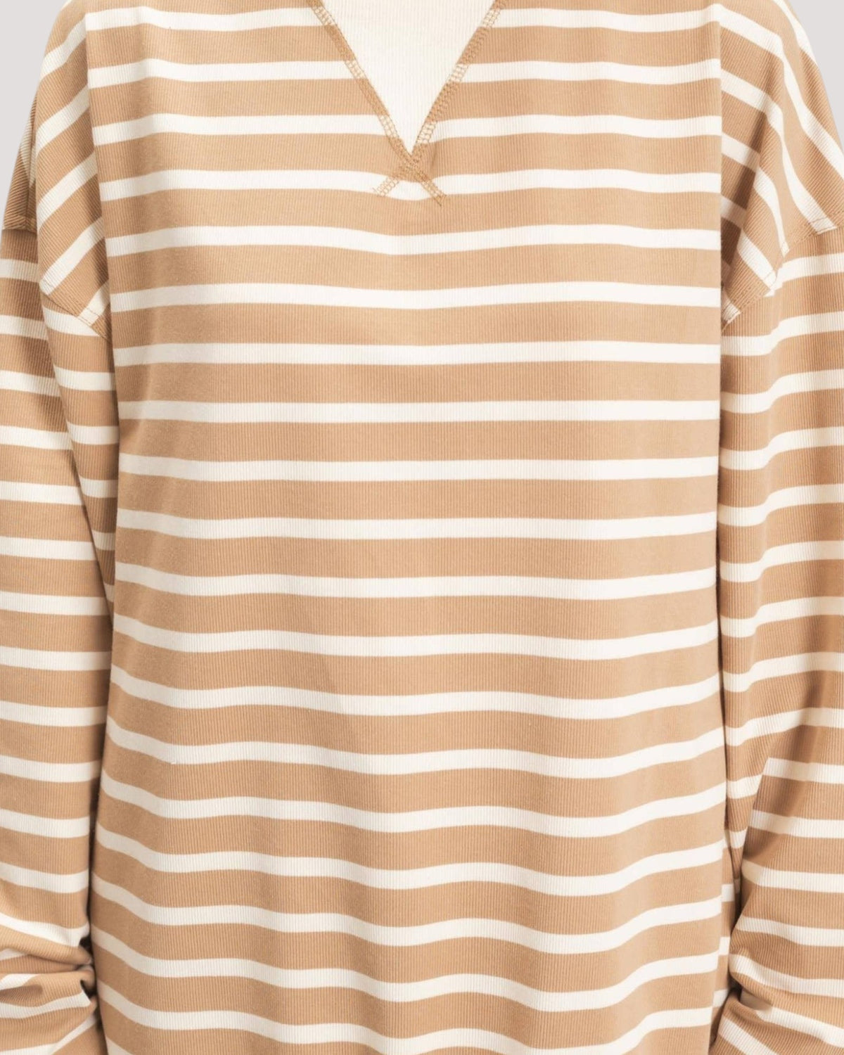 A close-up of a long-sleeve V-neck top with horizontal beige/tan and white stripes.