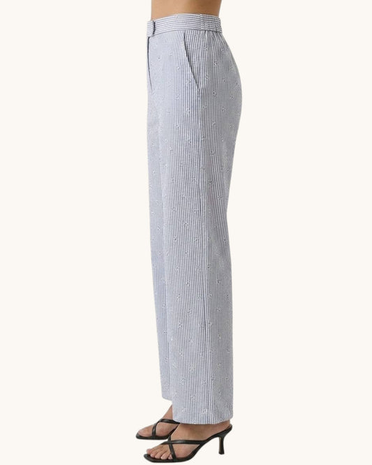 Striped pants worn by a person on a white background.
