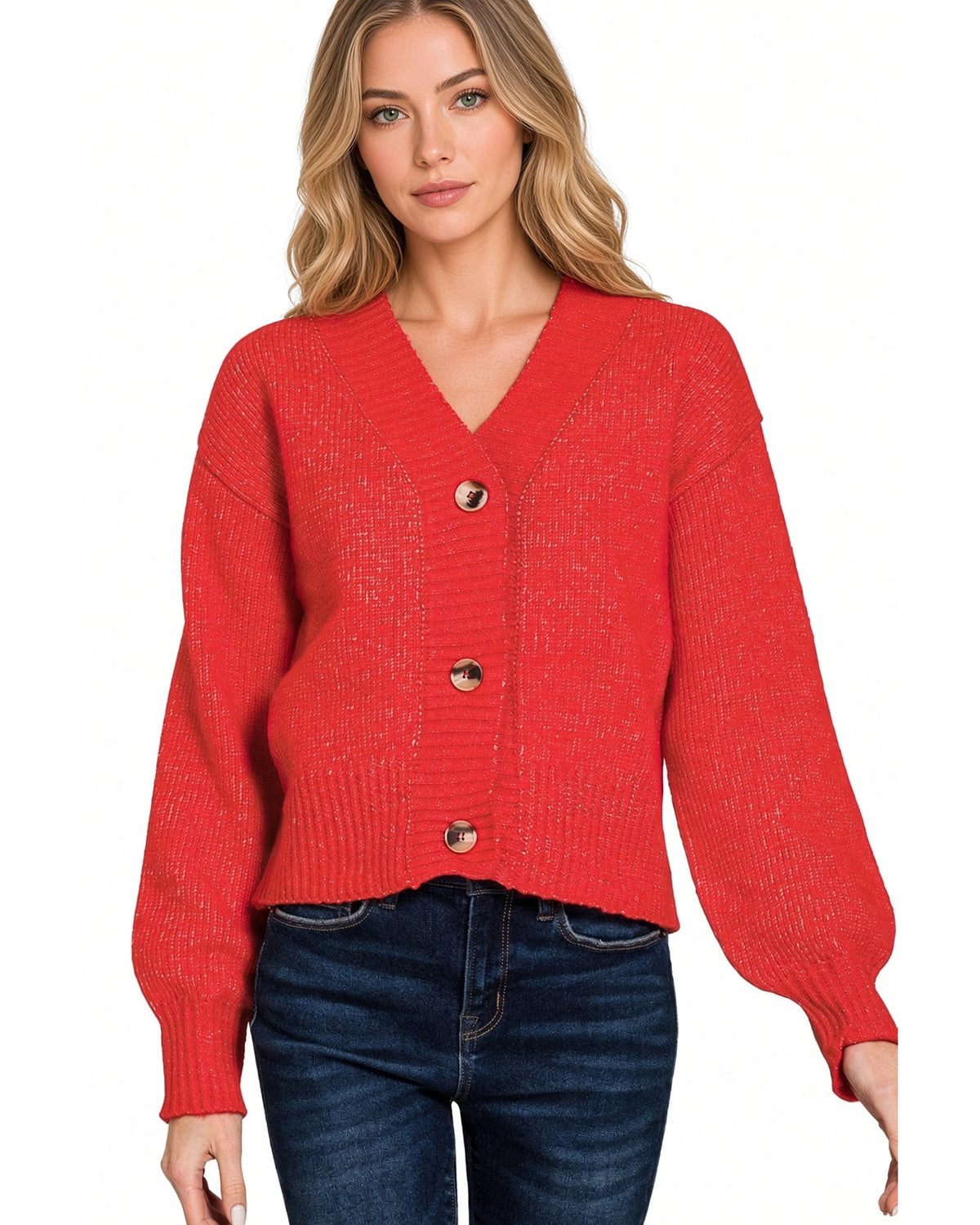 Model wearing a red cardigan knit sweater with 3 brown buttons that is cropped at waist.
