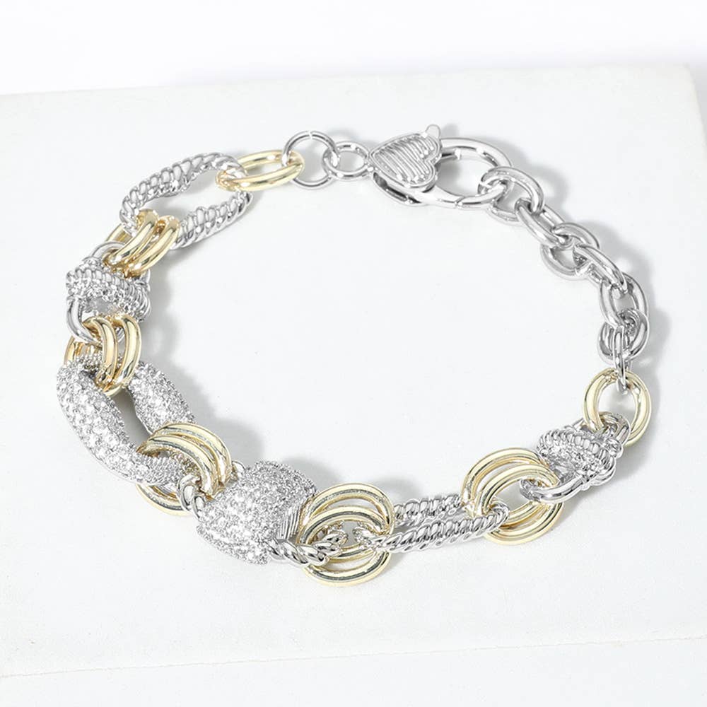 Silver and gold chain bracelet on a white background.