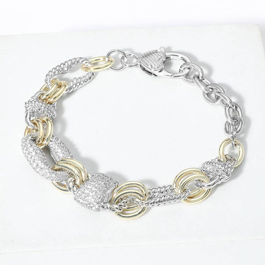 Silver and gold chain bracelet on a white background.