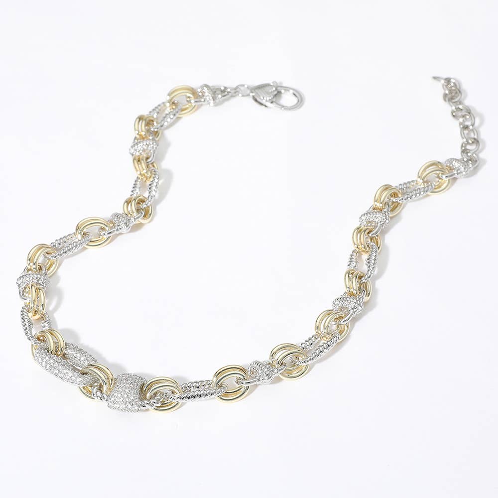Two-tone silver and gold necklace with CZ accents on a white background.