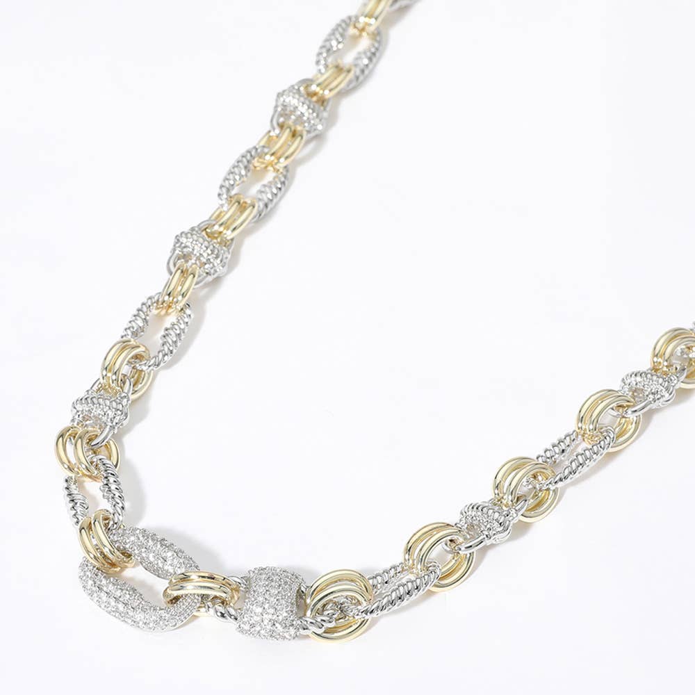 Gold and silver chain necklace with CZ accents on a white background.