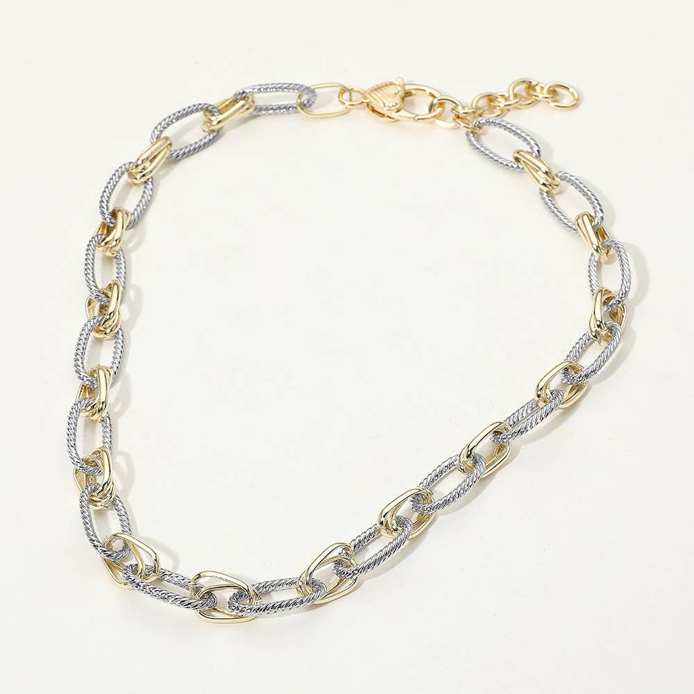 Two-tone gold and silver chain necklace on a white background.