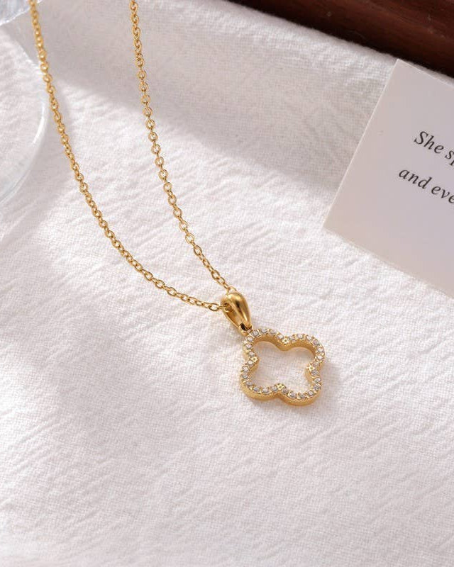 Gold clover and crystal open pendant on gold chain.