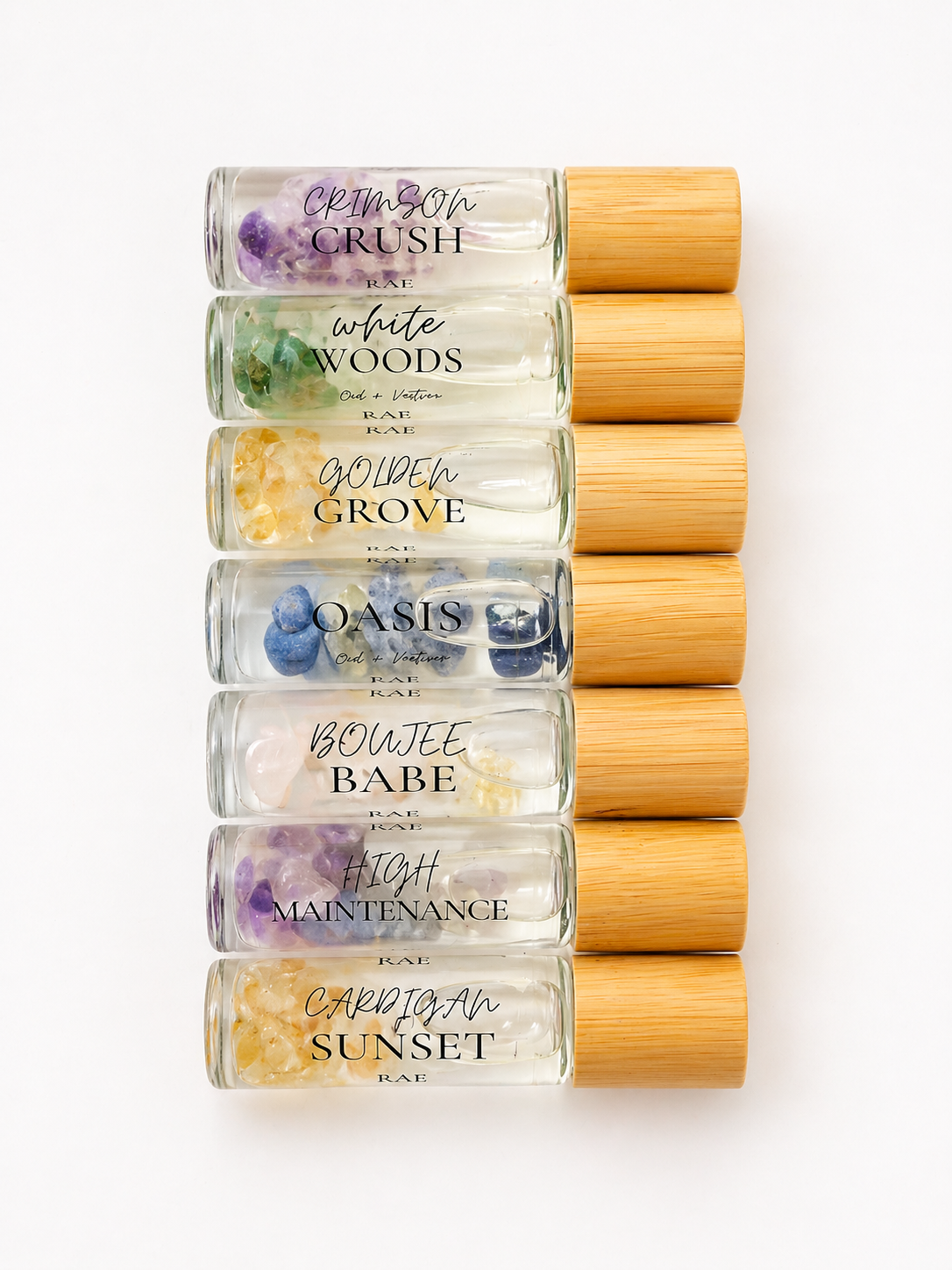 Set of rollerball bottles with bamboo caps on a white background.