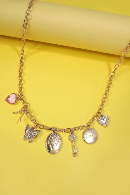 Gold charm necklace with a bow, heart, key, butterfly, and sparkling rhinestone accents.
