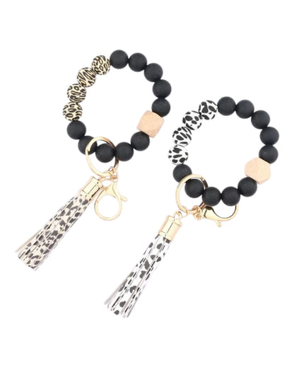 Cow print and animal print silicone bead and leather tassel keychain bracelet.