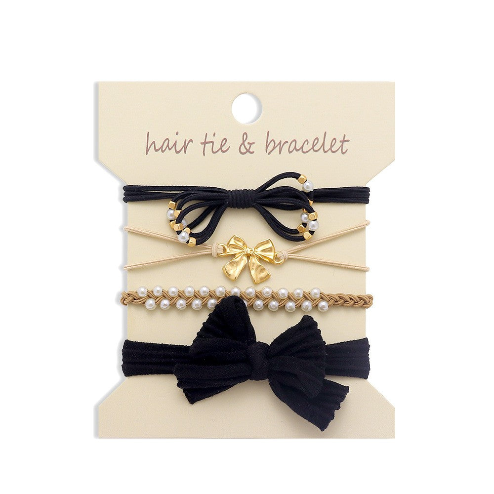 Set of hair ties and bracelets with bows and pearls on a beige card.
