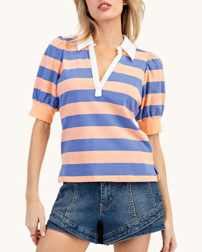 Woman wearing a striped shirt and denim shorts on a white background.