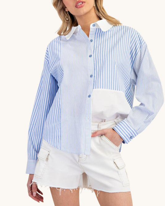 Woman wearing a blue and white striped shirt with a white collar and shorts on a white background.