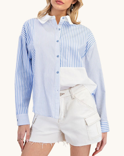 Woman wearing a blue and white striped shirt with a white collar and white shorts on a white background.