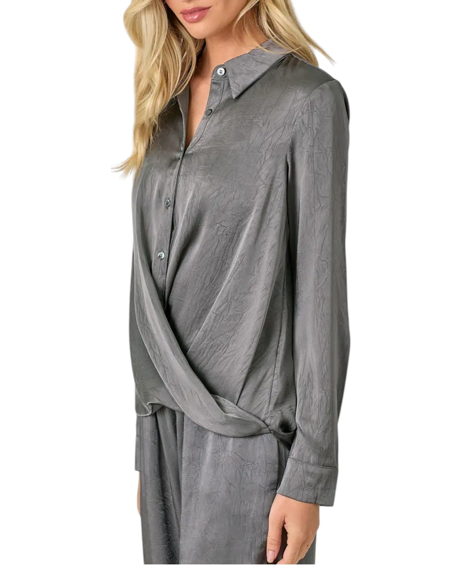 Woman wearing a grey button up crinkle satin twist front blouse. 