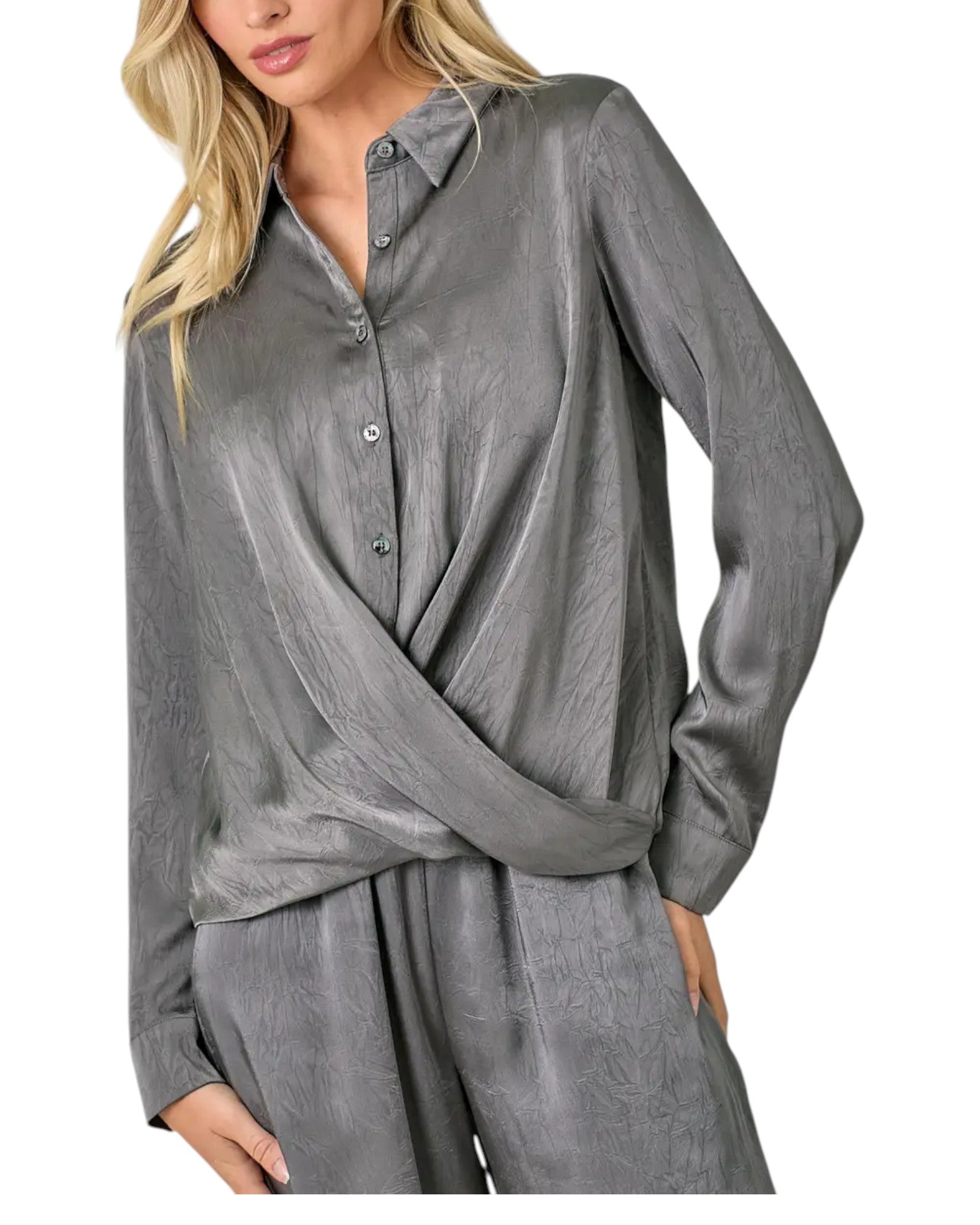 Woman wearing a grey button up crinkle satin twist front blouse. 