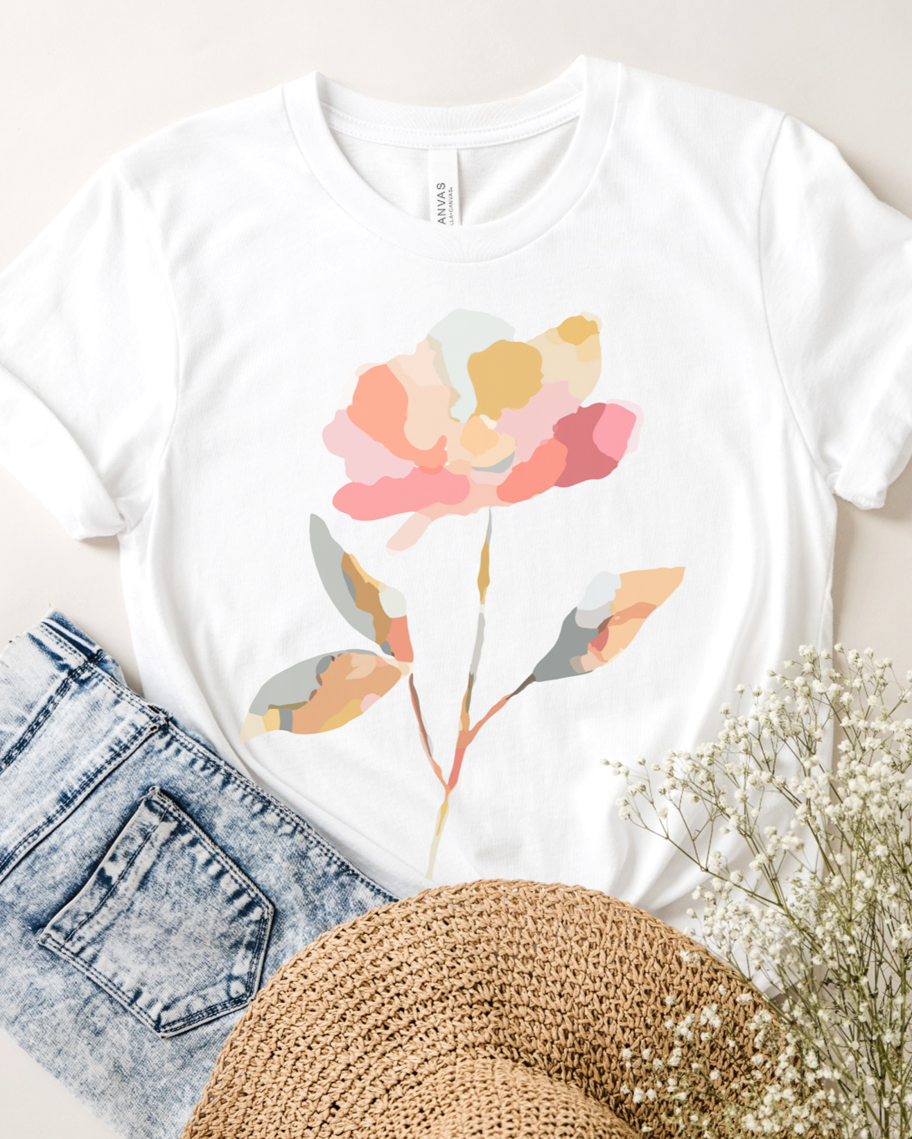 White tee with pastel watercolor abstract floral design.