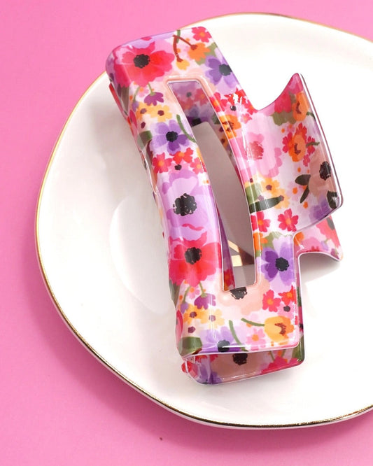 Bold floral-patterned hair claw clip.