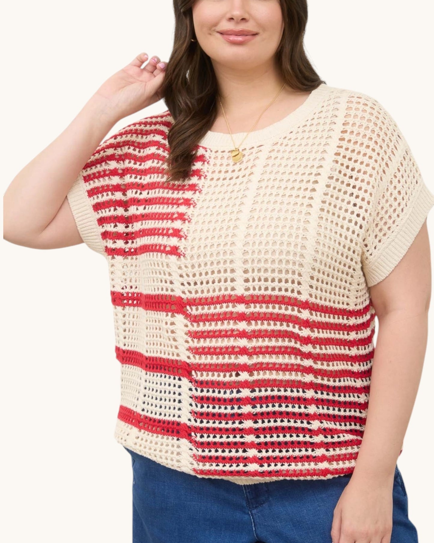 Woman wearing a red and white striped open knit crochet top on a white background, front view. Americana Red and Cream Open Knit Top.