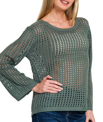 Woman wearing an Ash Jade Open Knit Crochet Sweater and jeans on white background. 