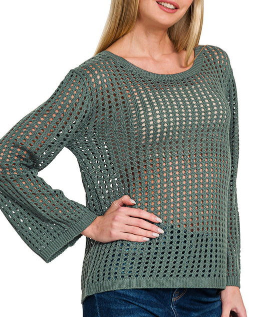 Woman wearing an Ash Jade Open Knit Crochet Sweater and jeans on white background. 