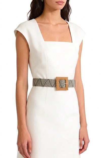 Woman in white dress wearing the black and white Wanderlust Boho Adjustable Buckle Belt.