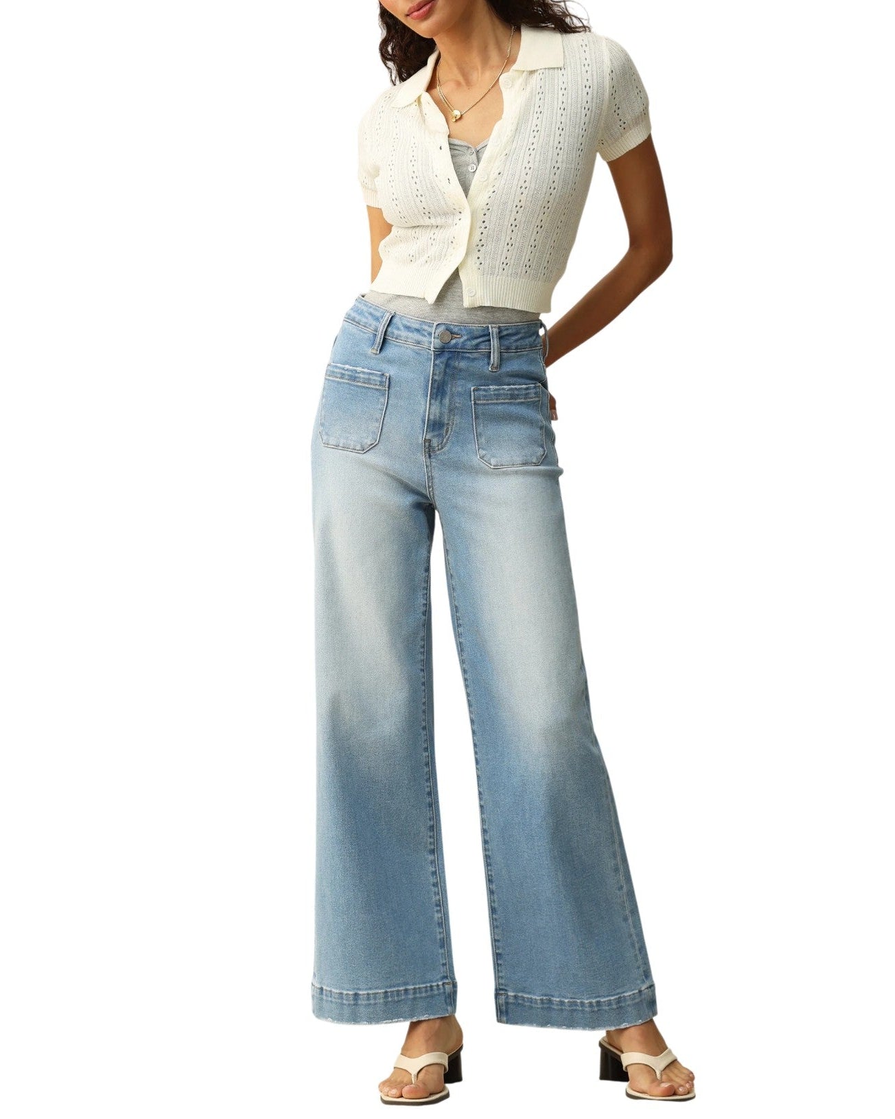 Woman wearing a white blouse and light blue jeans on a white background