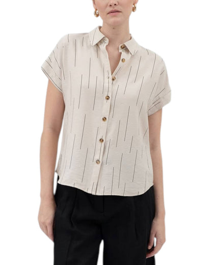Woman wearing a beige short-sleeve blouse with vertical black stripes on a white background.