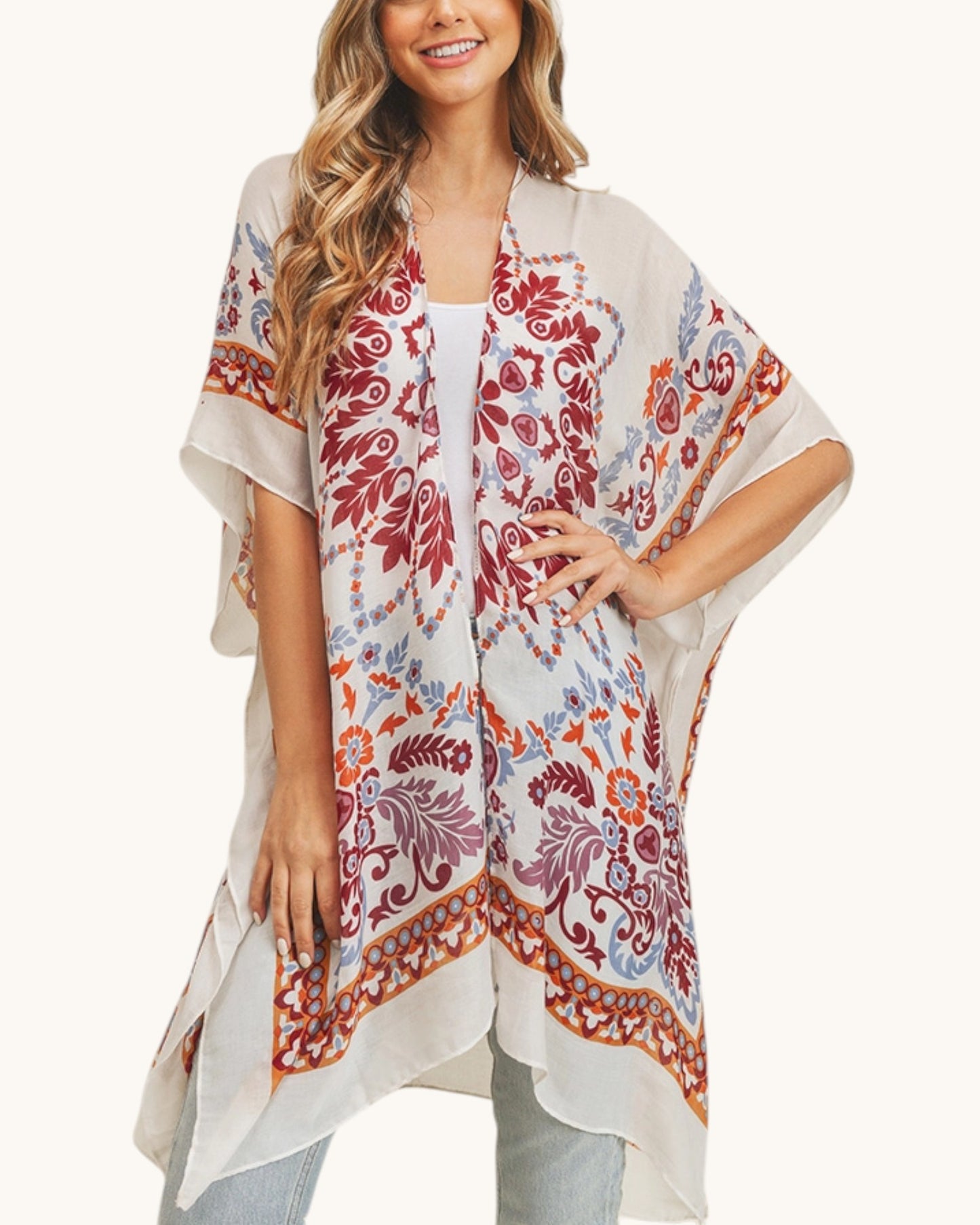 Woman wearing a patterned kimono-style garment on a white background.