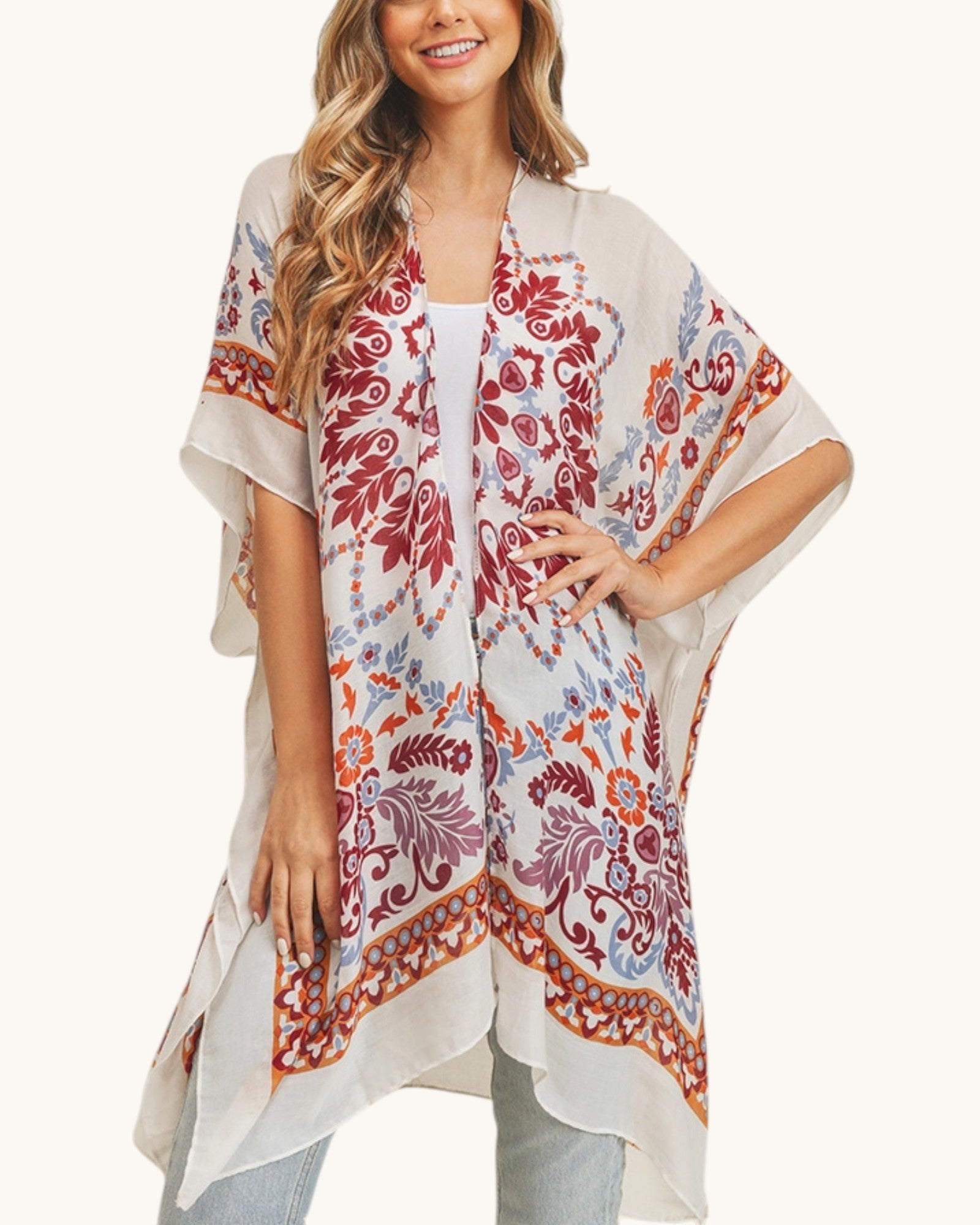 Woman wearing a patterned kimono-style garment on a white background.