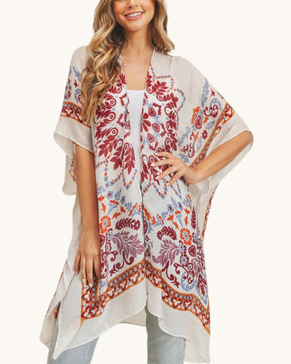 Woman wearing a patterned kimono-style garment on a white background.