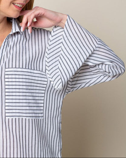 Woman wearing a black and white striped shirt against a beige background.