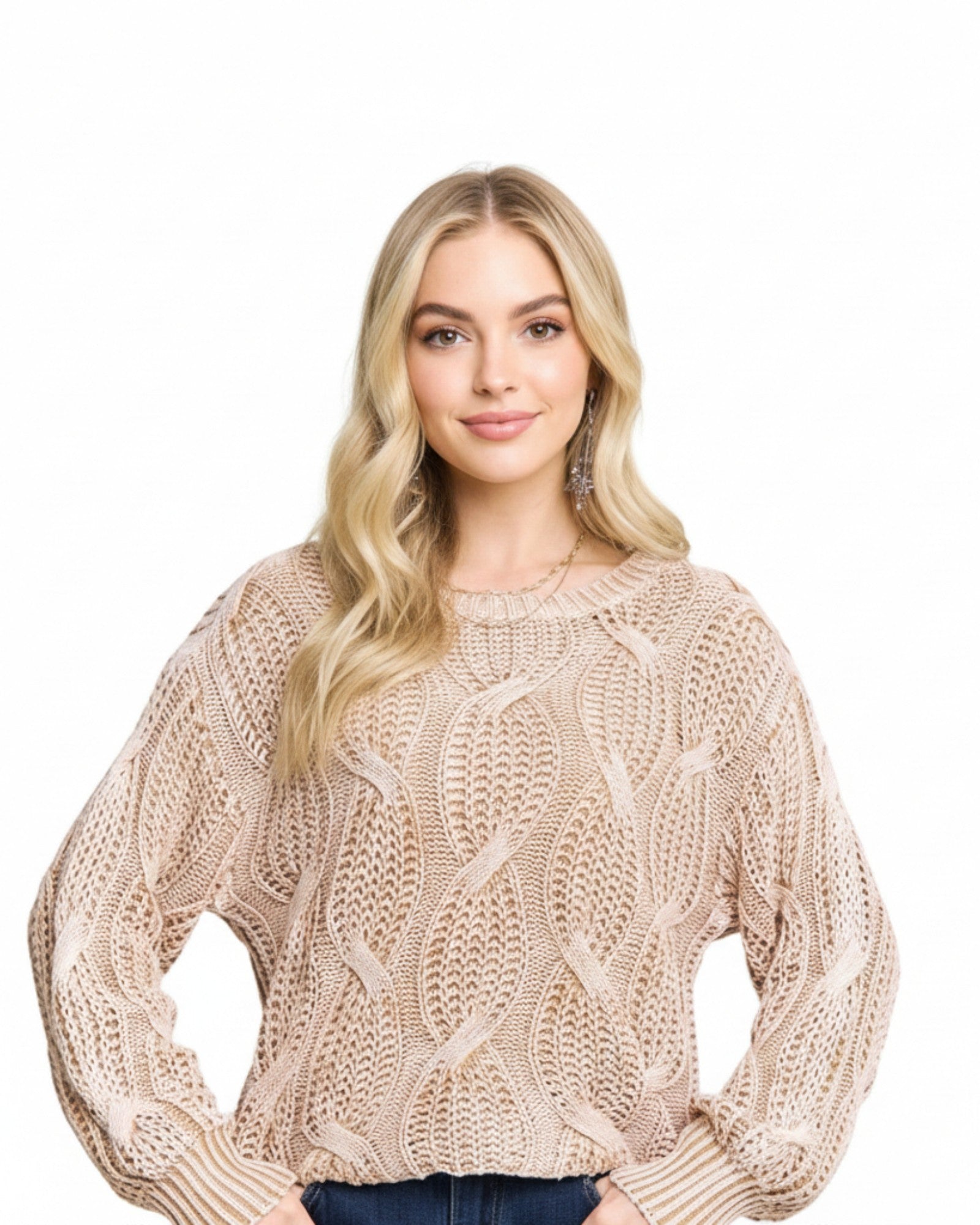 Woman wearing a beige knitted sweater on a white background.