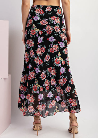 Black floral maxi skirt with red and purple blooms and A-line silhouette.