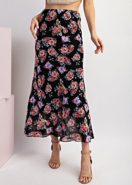 Black floral maxi skirt with red and purple blooms and A-line silhouette. 