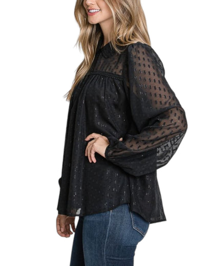 A black sheer jacquard blouse with shimmering gold accents, featuring a keyhole neckline, long voluminous sleeves, and a feminine gathered yoke detail.