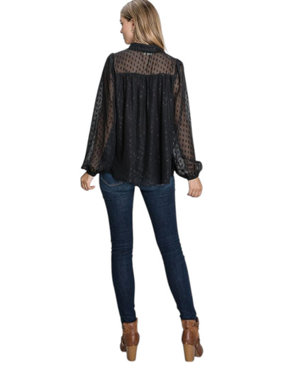 A black sheer jacquard blouse with shimmering gold accents, featuring a keyhole neckline, long voluminous sleeves, and a feminine gathered yoke detail.