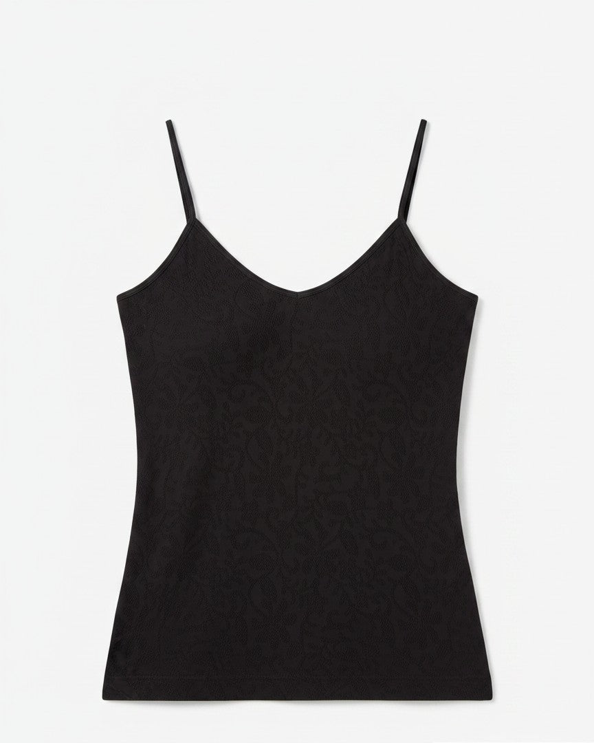 Black spaghetti strap top on a light background. 