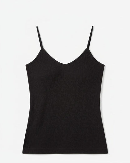 Black spaghetti strap top on a light background. 