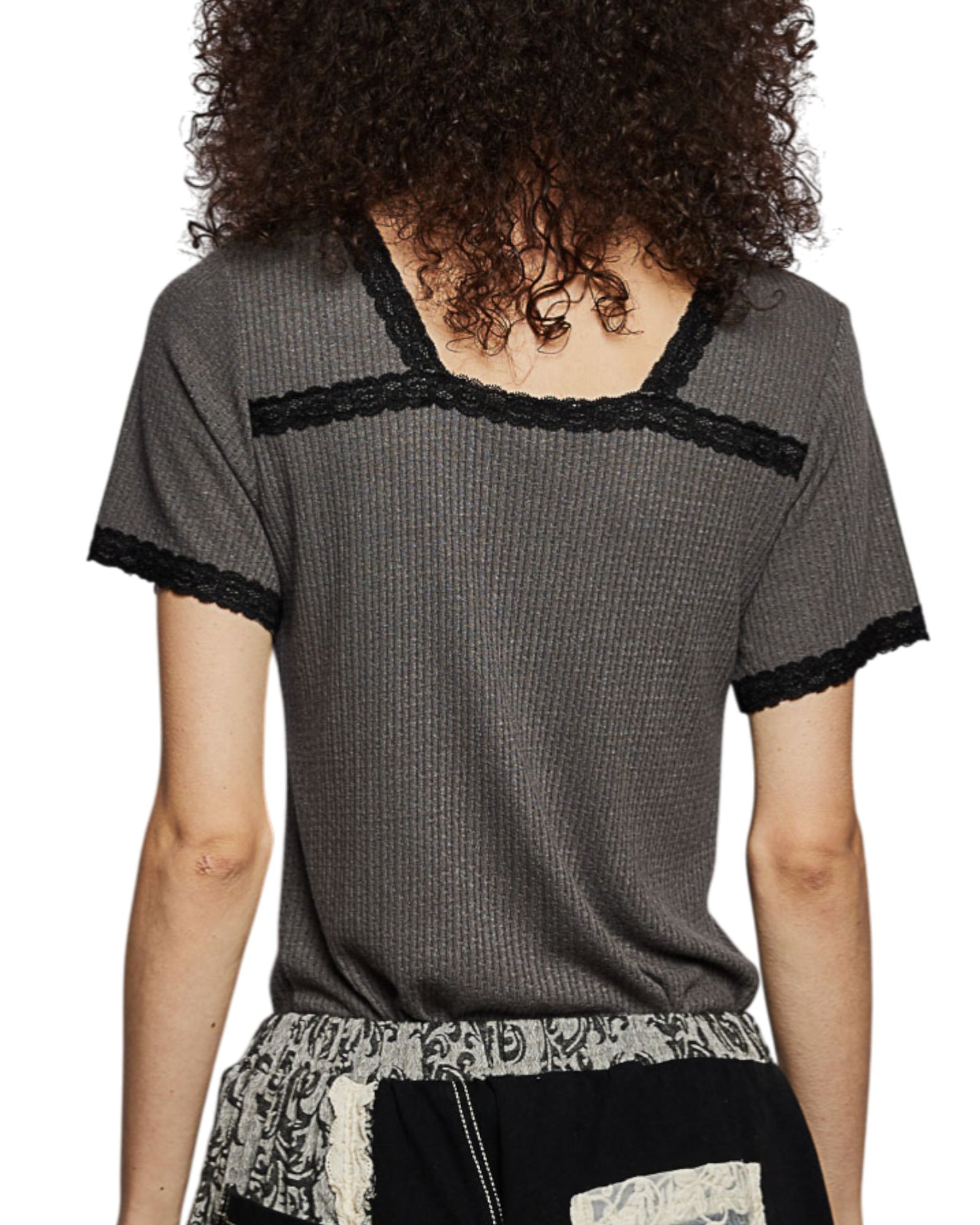 Person wearing a gray short-sleeve top with black trim on a white background