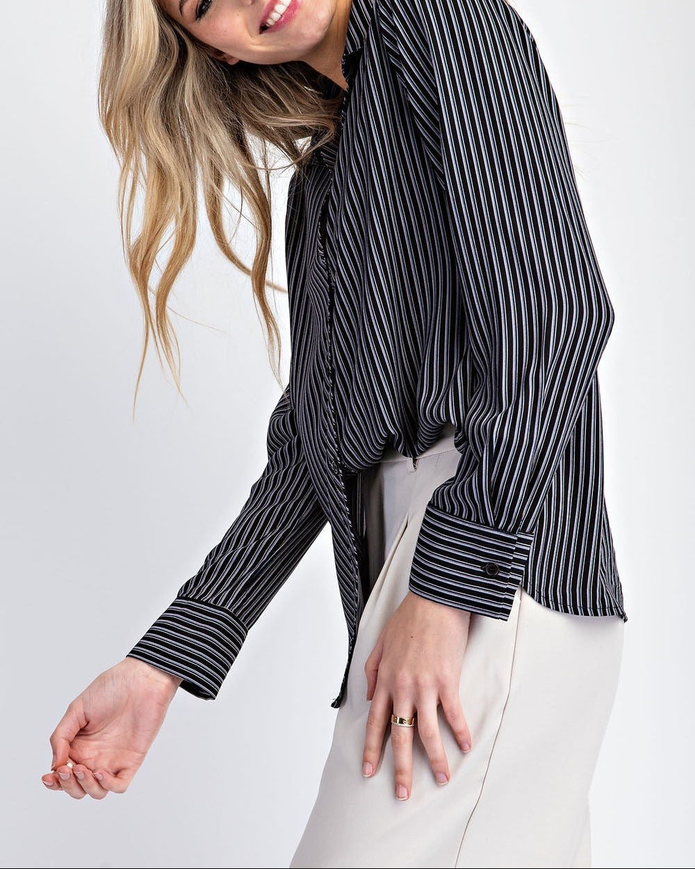 Woman wearing a black and white striped shirt on a white background